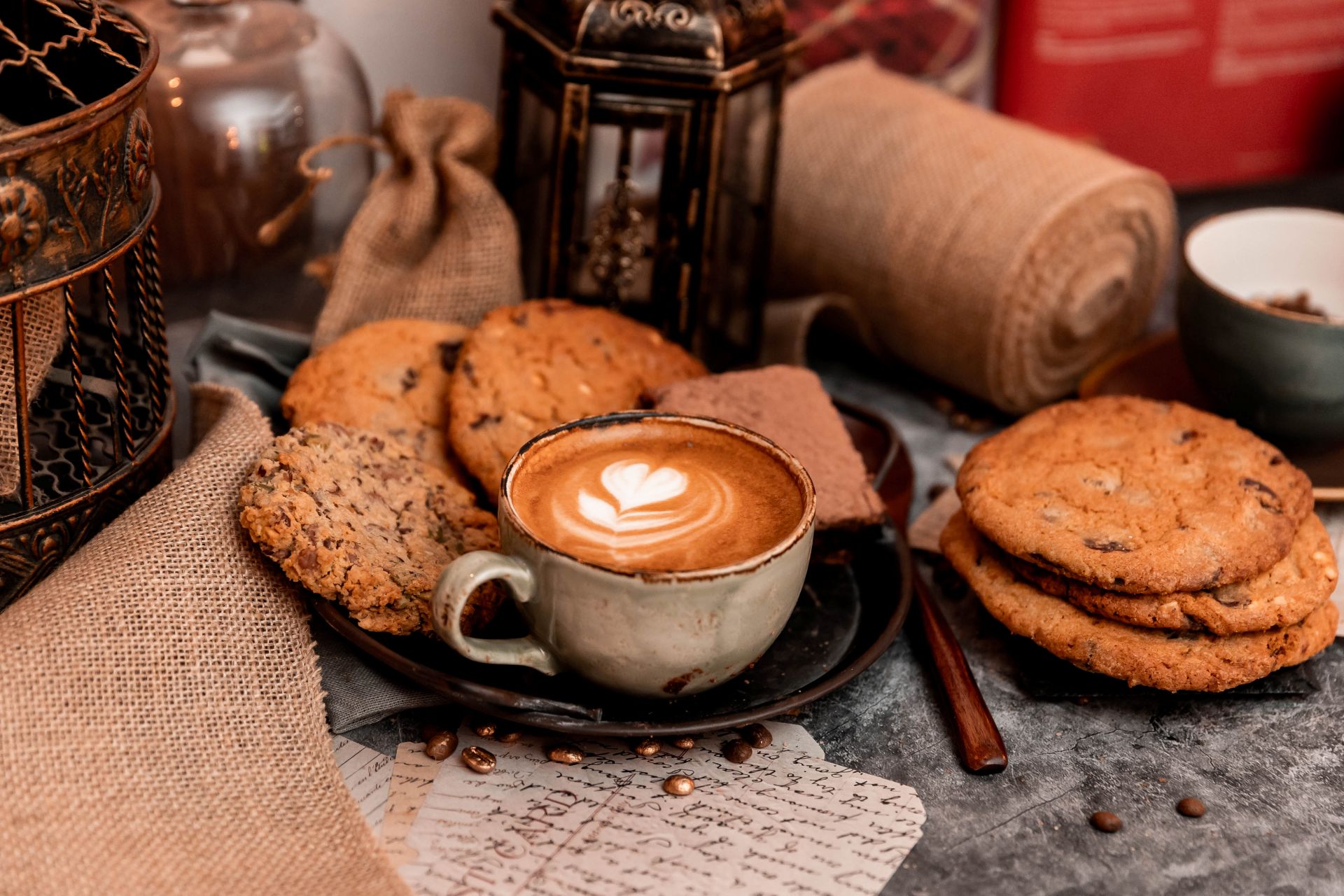 goldstruck cup of coffee and a plate of cookies